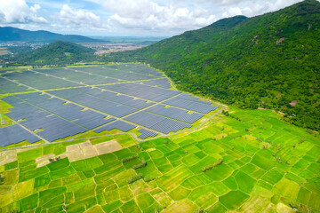 Rice fields interspersed with solar power fields in the morning, a combination of agriculture and...