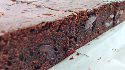 Close-up texture of fudgy and tender dark chocolate brownies which fresh baked from oven.