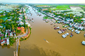 Floating village along Hau river over Vietnam border area, aerial view. The river basin contains a...