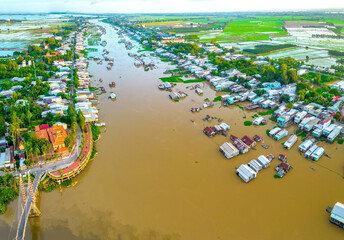 Floating village along Hau river over Vietnam border area, aerial view. The river basin contains a...