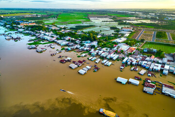 Floating village along Hau river over Vietnam border area, aerial view. The river basin contains a...