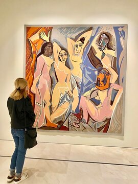 30.10.2021. Malaga, Spain. blond girl standing in front of Pablo Picasso's one of the most famous painting called Les Demoiselles dAvignon in Picasso Musseum in Malaga. High quality photo