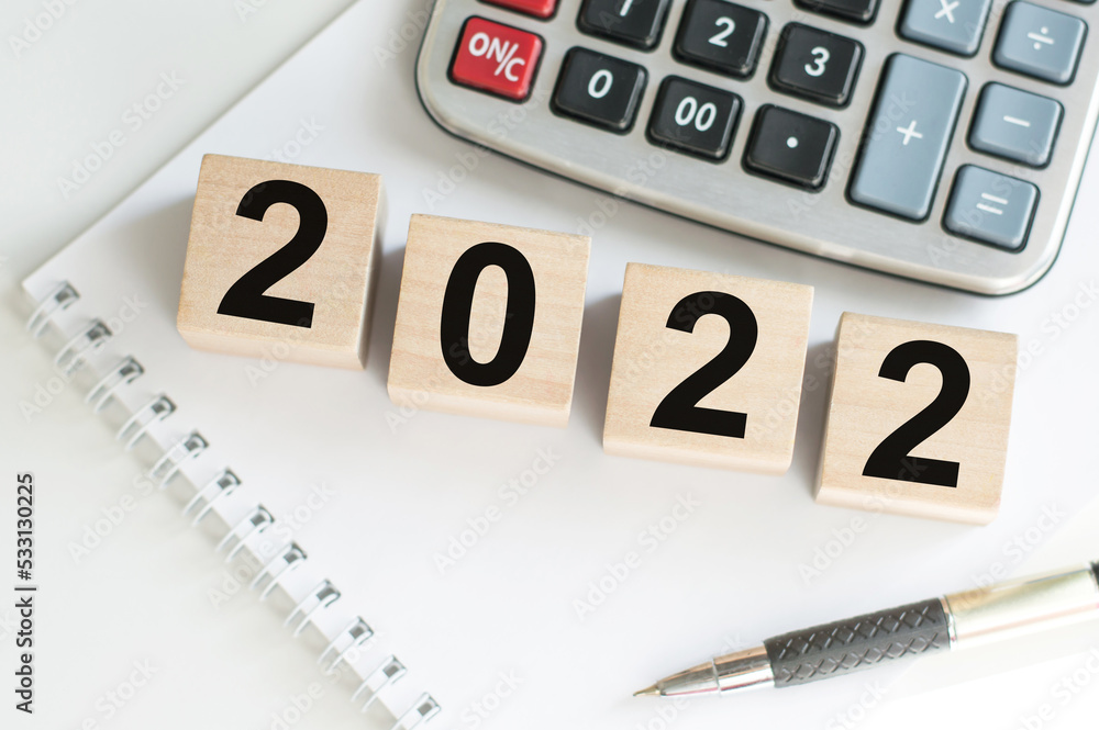 Poster 2022 cubes with red heart shape and empty notebook on table for your text. new year, resolution, goa