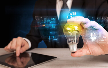 Businessman holding a light bulb, online security concept