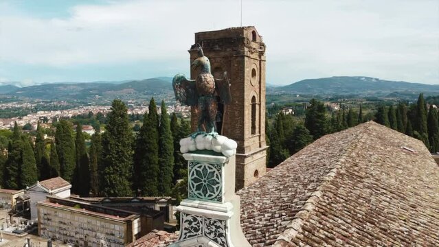 the top of the church is an iron eagle. Church of San Miniato in Florence, Toscana, Italy. Aerial view . High quality 4k footage