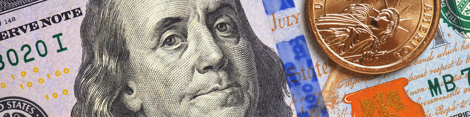 American money close-up. 100 dollar banknote and 1 dollar coin. Benjamin Franklin and Statue of...