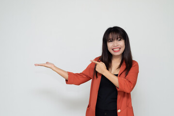 close up attractive adult business woman asian girl hand pointing with happy and smile against white concrete wall office with concrete background and blank copy space.