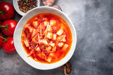 red vegetable soup borsch beetroot, cabbage, tomato, onion healthy meal food snack diet on the table copy space food background rustic top view keto or paleo diet veggie vegan or vegetarian food