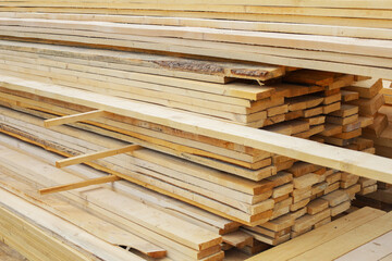 Woodworking plant. Stacked lumber in the street. Folded wood for frame house. Closeup wooden...
