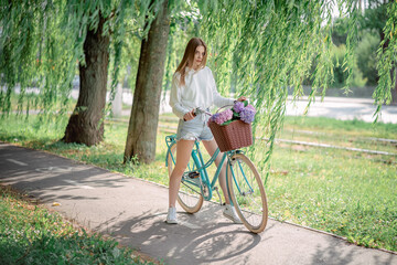 beautiful girl on a bicycle with flowers