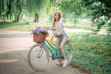 beautiful girl on a bicycle with flowers
