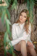 beautiful fair-haired girl outside among the trees