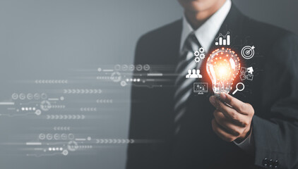 Light bulb shining in the hand of businessman. Concept of Ideas for presenting new ideas Great...