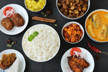 Rice and non vegetarian curry for Christmas special food in Kerala India. Indian pork fish beef prawns curry with white rice cutlet  appam.