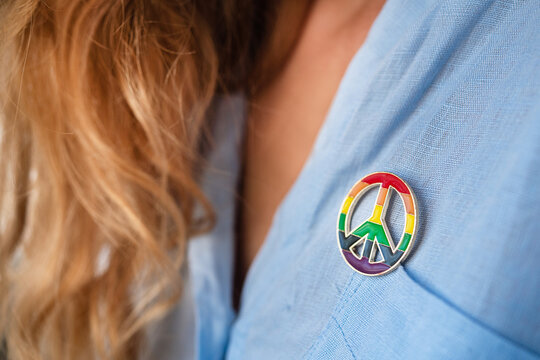Woman with peace symbol and lgbt colors