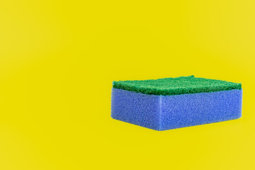 Color sponge dishwashing isolated on yellow background