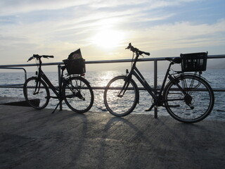 bicycles on the beach at sunset