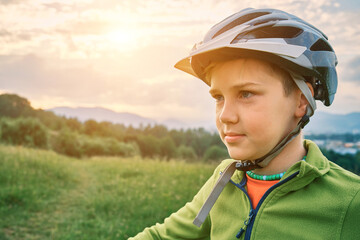 Happy cute boy in helmet ride bicycle