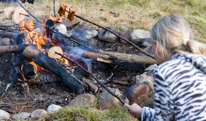 baking sausages at a scout camp