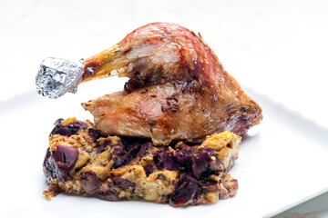 bake poultry leg served with stuffing with red beans