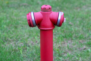 Pipe fittings in the form of a fire hydrant in red close-up with copyspace