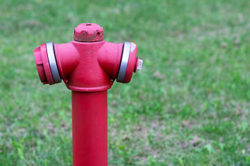 Pipe fittings in the form of a fire hydrant in red close-up with copyspace