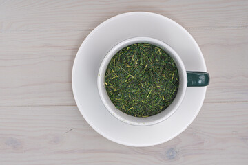 Top view green tea cup on white wooden background