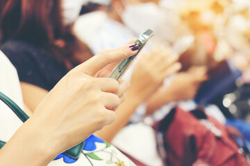 Hand of woman text message on smart phone or technology. Girl using cellphone on building castle background close. Tourist female hands holding gadget on blurred airport background.