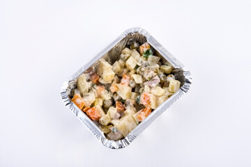 Olivier salad served in aluminium tray