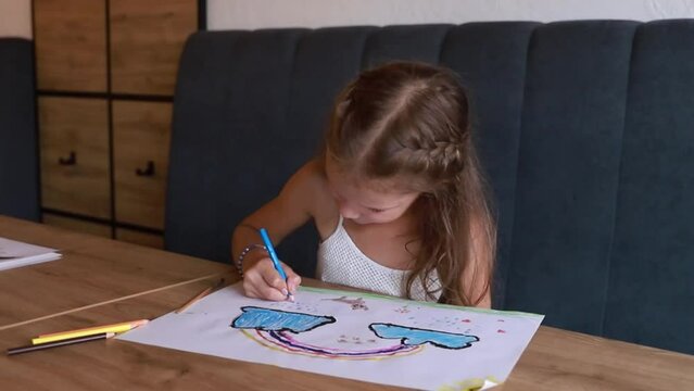 The little girl is an artist. Child learns to paint