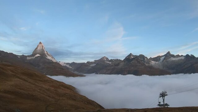 Timelapse Sea of mist at Matterhorn Mountain near Bruder Klaus, Riffelberg Chapel, Riffelsee Zermatt, Switzerland.