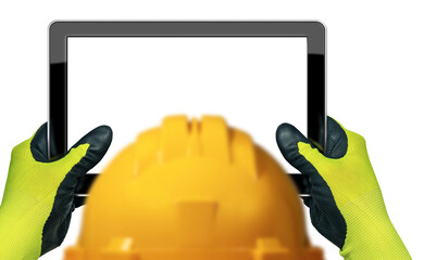 Construction worker with yellow hard hat and hands with protective gloves, holding an empty digital...