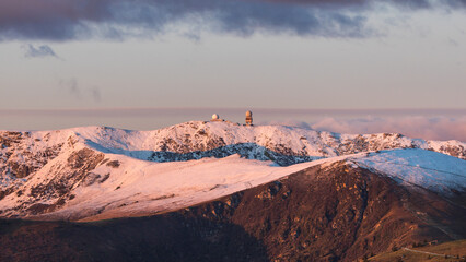 First snow on the peak of the Koralpe and first rays of sun on a cold winter morning in Austria