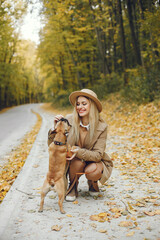 Young blonde girl walking with a little puppy french bulldog