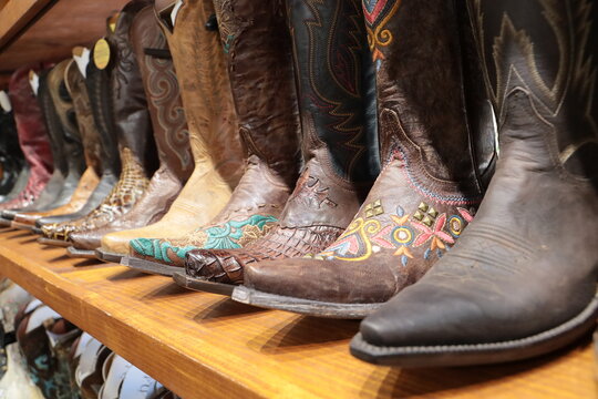 A long row of cowboy boots on sale at a store in Texas