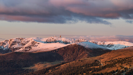 First snow on the peak of the Koralpe and first rays of sun on a cold winter morning in Austria