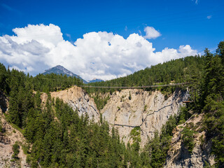 Fototapeta na wymiar canyon in the rocky mountains with suspension bridge across