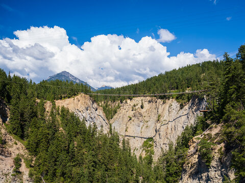 canyon in the rocky mountains with suspension bridge across