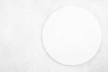 Marble round cutting board flat lay mockup on gray concrete stone background. Top view. Copy space.