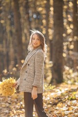 Portrait of a young woman in autumn forest