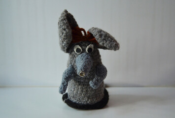Funny knitted figurine of a gray mouse made by hand. DIY toys for children. Funny animal...