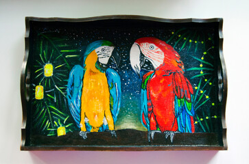 Beautiful coffee tray painted with acrylics. Romantic date of two parrots by artist Anastasiia Popova. Beautiful scarlet Ara macaw, large red parrot, and blue-and-yellow macaw. Neotropical parrots