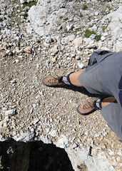 mountain boots at the foot of the hiker during the walk on the mountain path