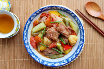 Sweet and sour pork - Chinese famous dish on bamboo placemat 