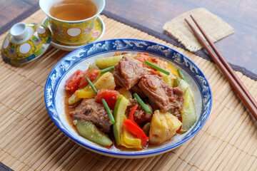 Sweet and sour pork - Chinese famous dish on bamboo placemat at close up view