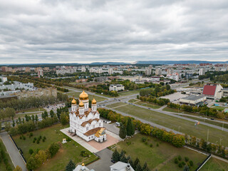 Transfiguration Cathedral, the church of the 21st century against the backdrop of the urban landscape. A bird's-eye view of the horizon on an autumn day. Bird's-eye view.