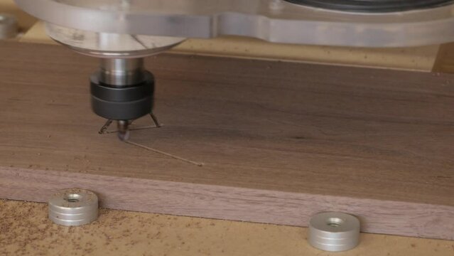 A CnC cutting a 12 sided die into the lid of a dice box lid