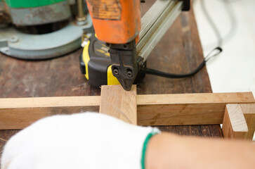 Young man doing woodworking hobby in his workshop, soft focus.
