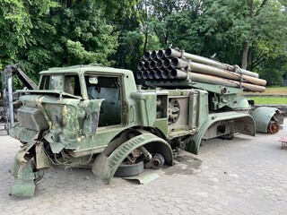 The Russian artillery system of salvo fire stands neutralized on the street of the city. Destroyed military equipment in the city. Destroyed military equipment during military operations on the battle