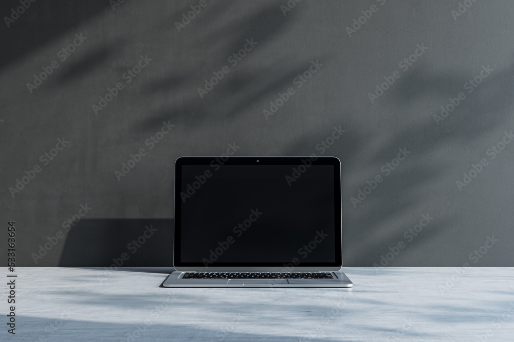 Aufkleber Close up of laptop with empty screen and mock up place at concrete workplace with shadows. 3D Rendering.